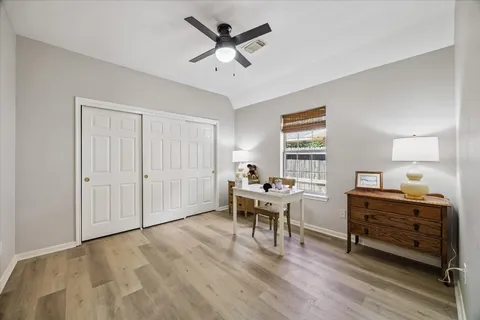 a workspace with wooden floor and windows