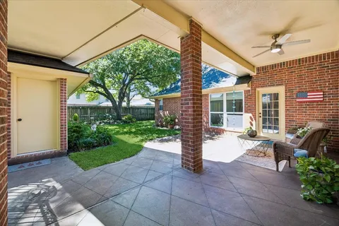 a view of a patio with table and chairs and potted plants