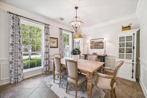 a view of a dining room with furniture large windows and wooden floor