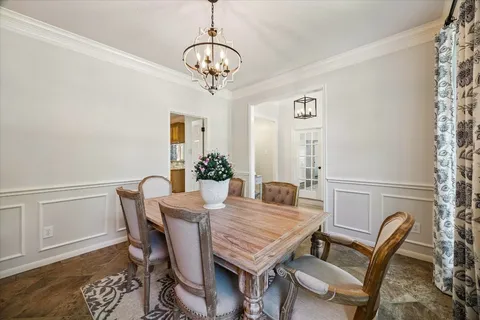 a view of a dining room with furniture wooden floor and chandelier