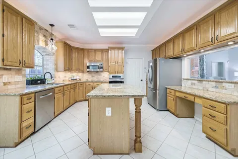 a kitchen with stainless steel appliances granite countertop a stove sink and cabinets