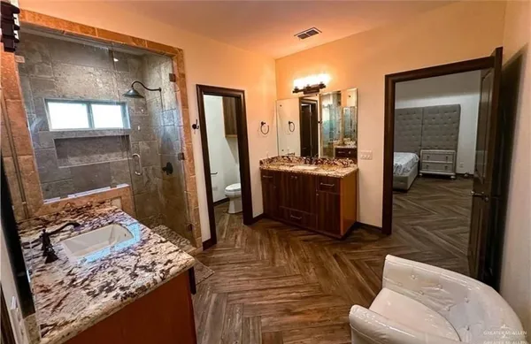 a view of living room kitchen with stainless steel appliances granite countertop sink and stove top oven