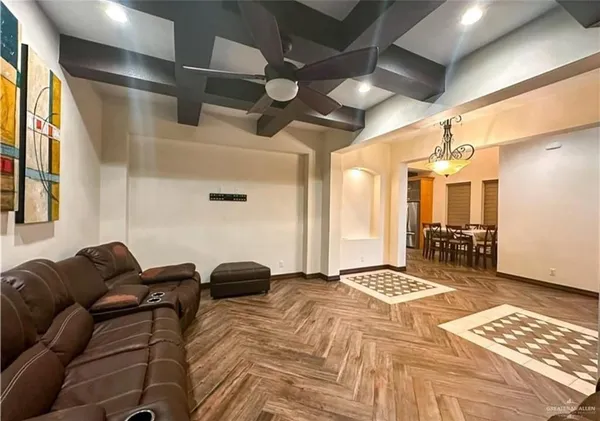 a spacious bedroom with a bed and a chandelier