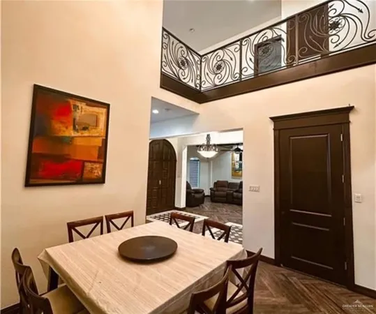 a table with chairs and paintings on the wall