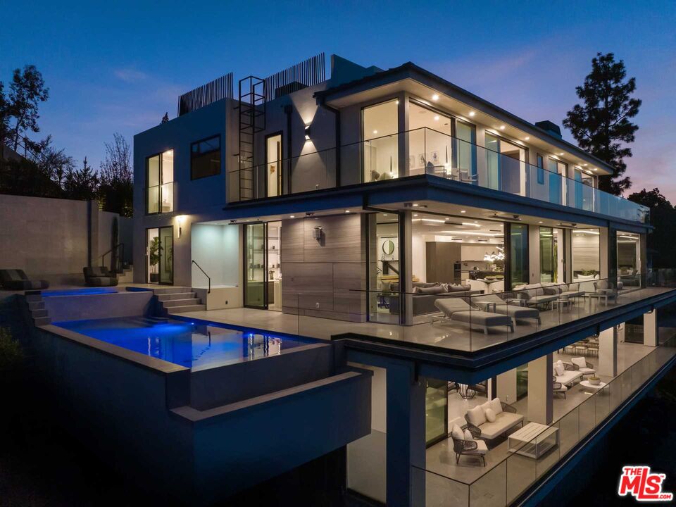 a front view of house with roof deck and seating space