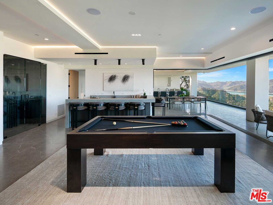 1324 Stradella Road Los Angeles, CA 90077 - Photo 11 of 26 a kitchen with kitchen island a sink stove and a refrigerator
