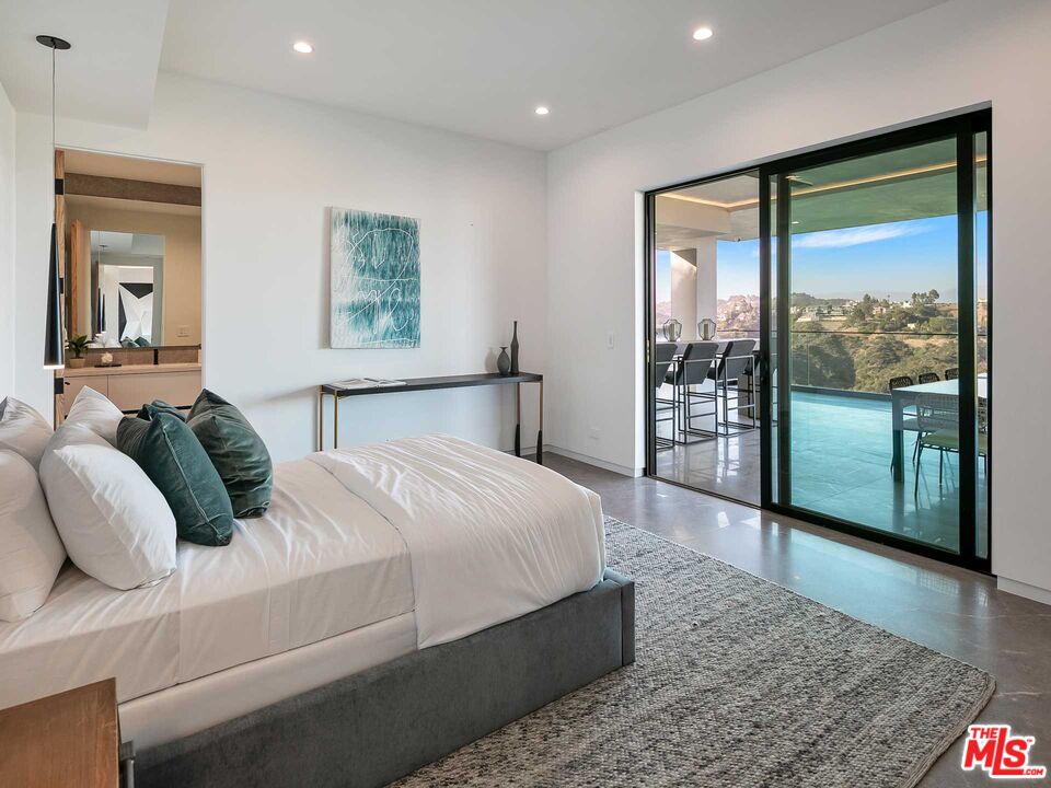1324 Stradella Road Los Angeles, CA 90077 - Photo 12 of 26 a bedroom with a large bed and a large window
