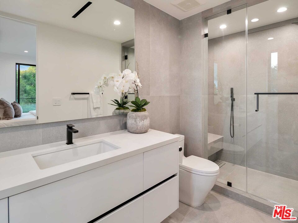 1324 Stradella Road Los Angeles, CA 90077 - Photo 16 of 26 a bathroom with a sink a toilet and shower