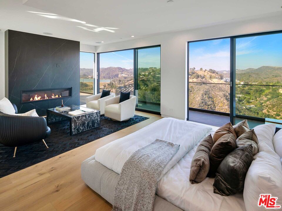 1324 Stradella Road Los Angeles, CA 90077 - Photo 17 of 26 a bedroom with furniture and large windows