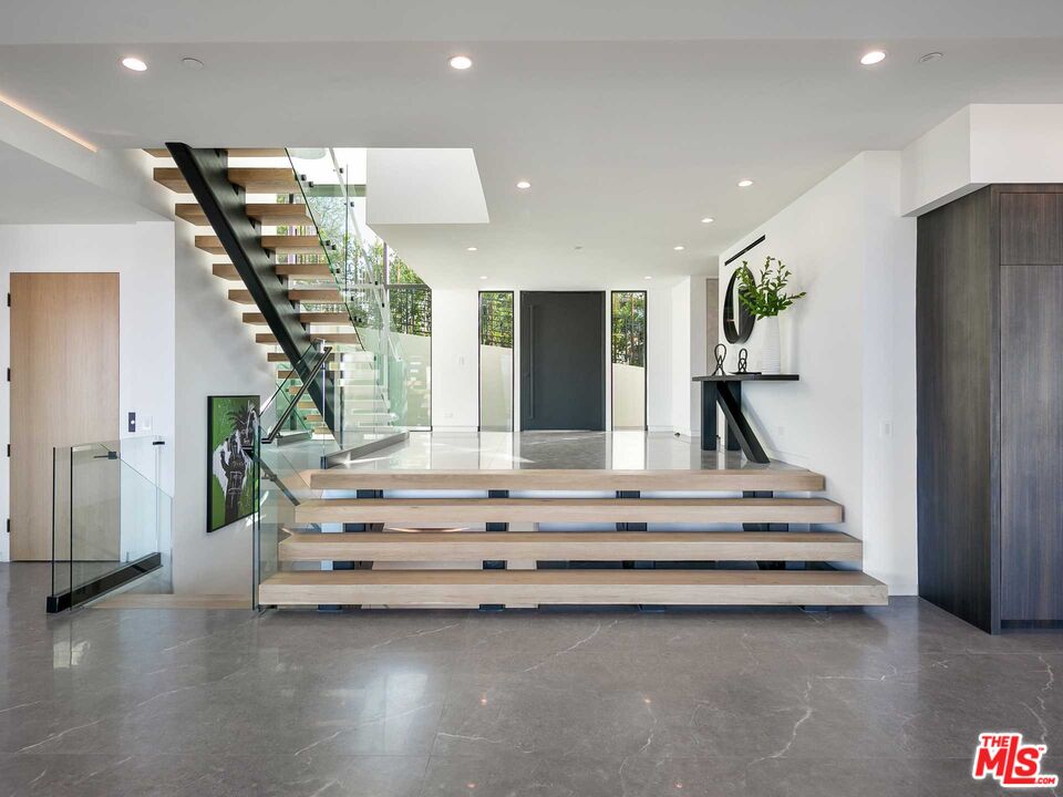 1324 Stradella Road Los Angeles, CA 90077 - Photo 2 of 26 a view of hall with wooden floor and staircase