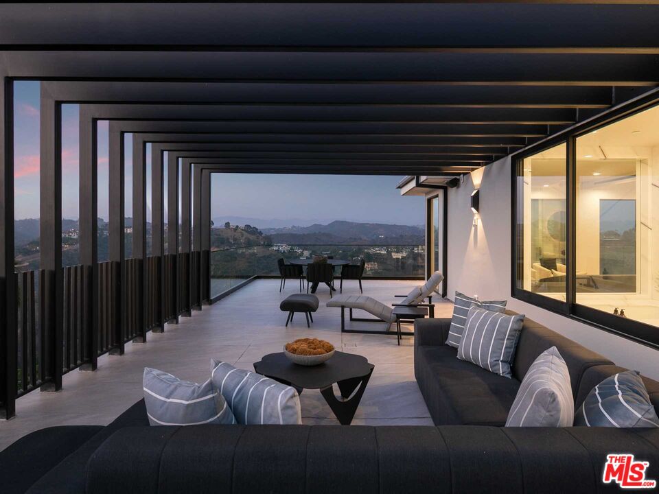 1324 Stradella Road Los Angeles, CA 90077 - Photo 21 of 26 a living room with furniture and a large window