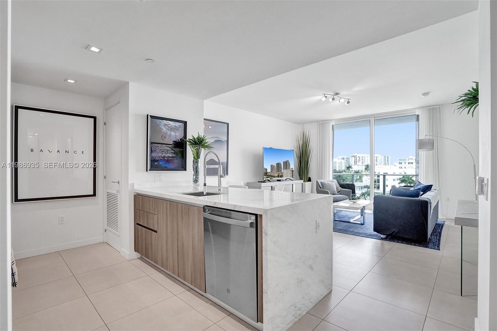 401 North Birch Road, Unit 513 Fort Lauderdale, FL 33304 - Photo 14 of 37 a kitchen with kitchen island cabinets and refrigerator