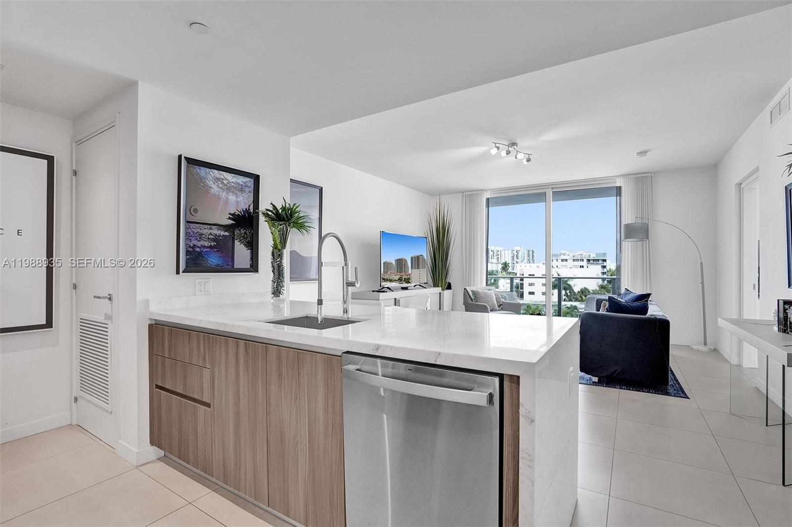401 North Birch Road, Unit 513 Fort Lauderdale, FL 33304 - Photo 15 of 37 a kitchen with stainless steel appliances kitchen island granite countertop a sink and cabinets