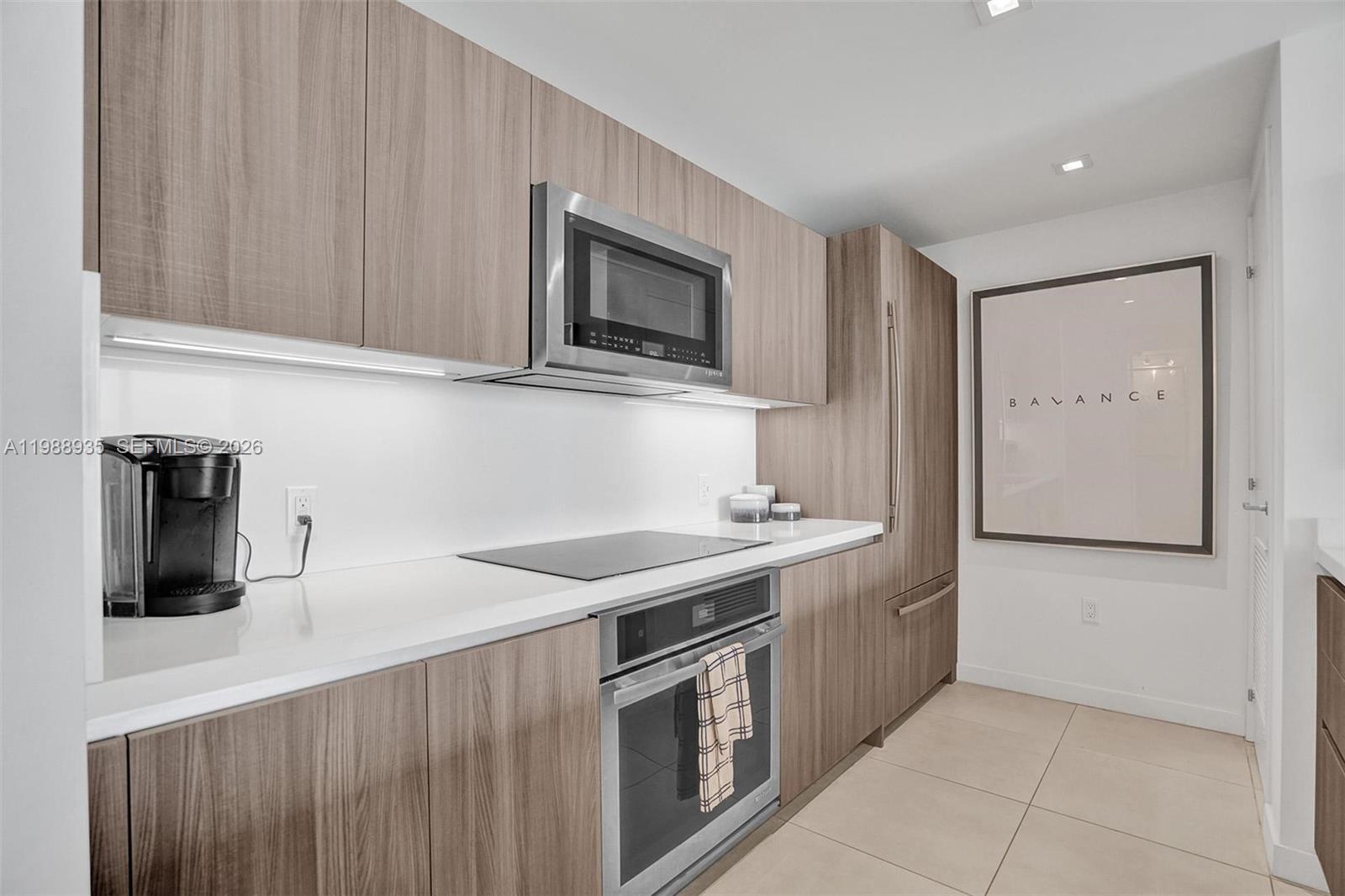 401 North Birch Road, Unit 513 Fort Lauderdale, FL 33304 - Photo 16 of 37 a kitchen with stainless steel appliances granite countertop a sink and a microwave