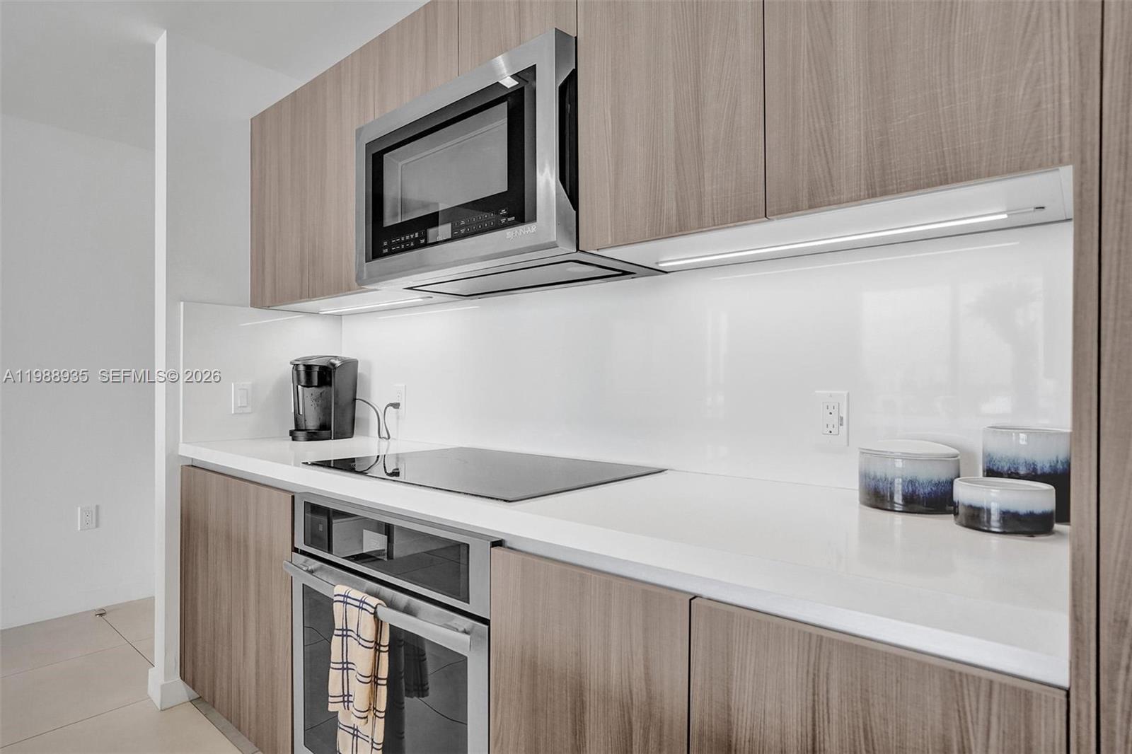401 North Birch Road, Unit 513 Fort Lauderdale, FL 33304 - Photo 17 of 37 a kitchen with a sink cabinets and microwave
