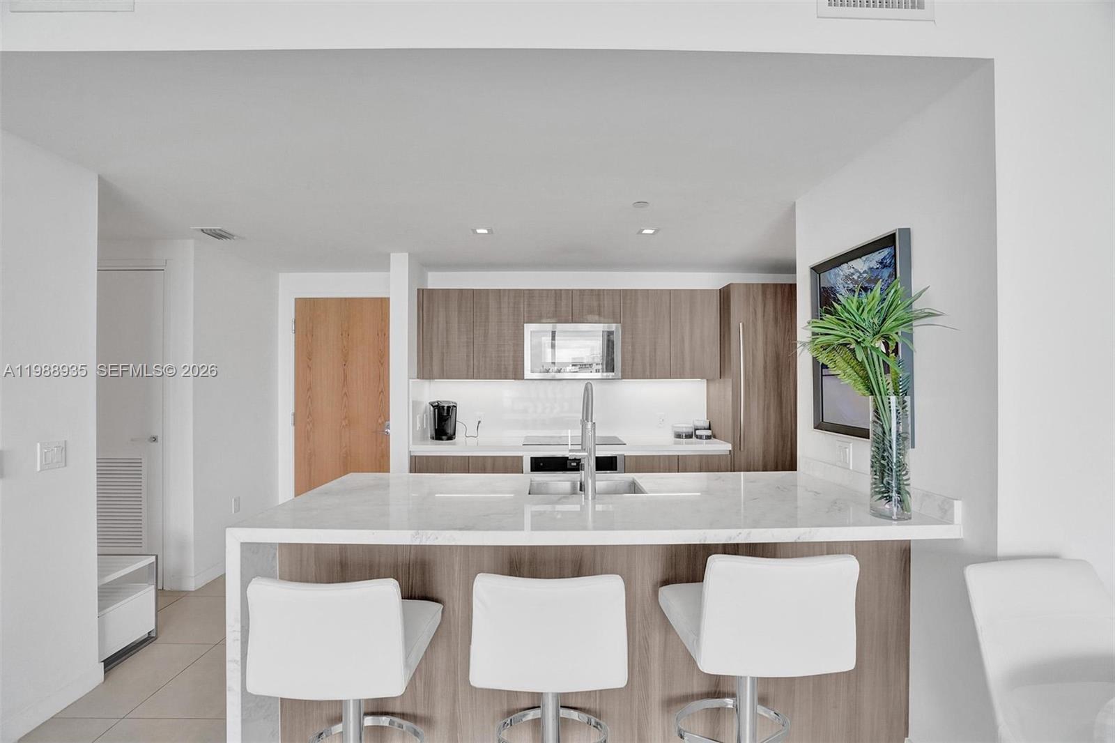 401 North Birch Road, Unit 513 Fort Lauderdale, FL 33304 - Photo 22 of 37 a kitchen with a table chairs stove and cabinets