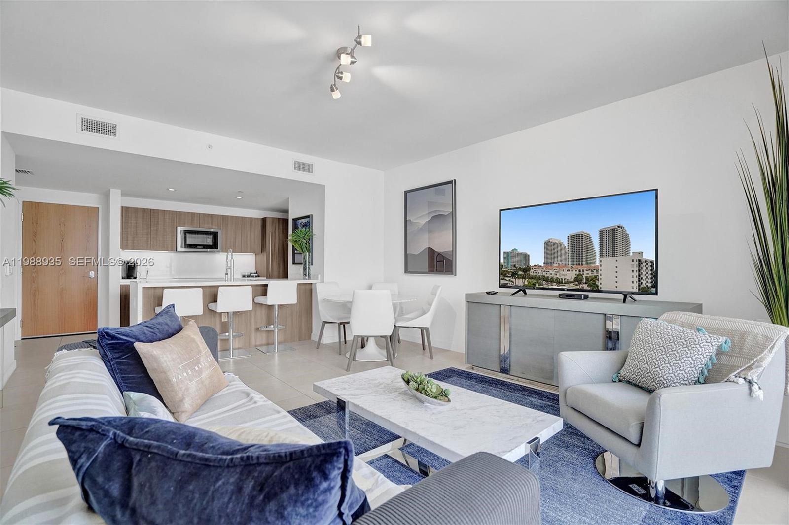 401 North Birch Road, Unit 513 Fort Lauderdale, FL 33304 - Photo 26 of 37 a living room with furniture kitchen view and a wooden floor