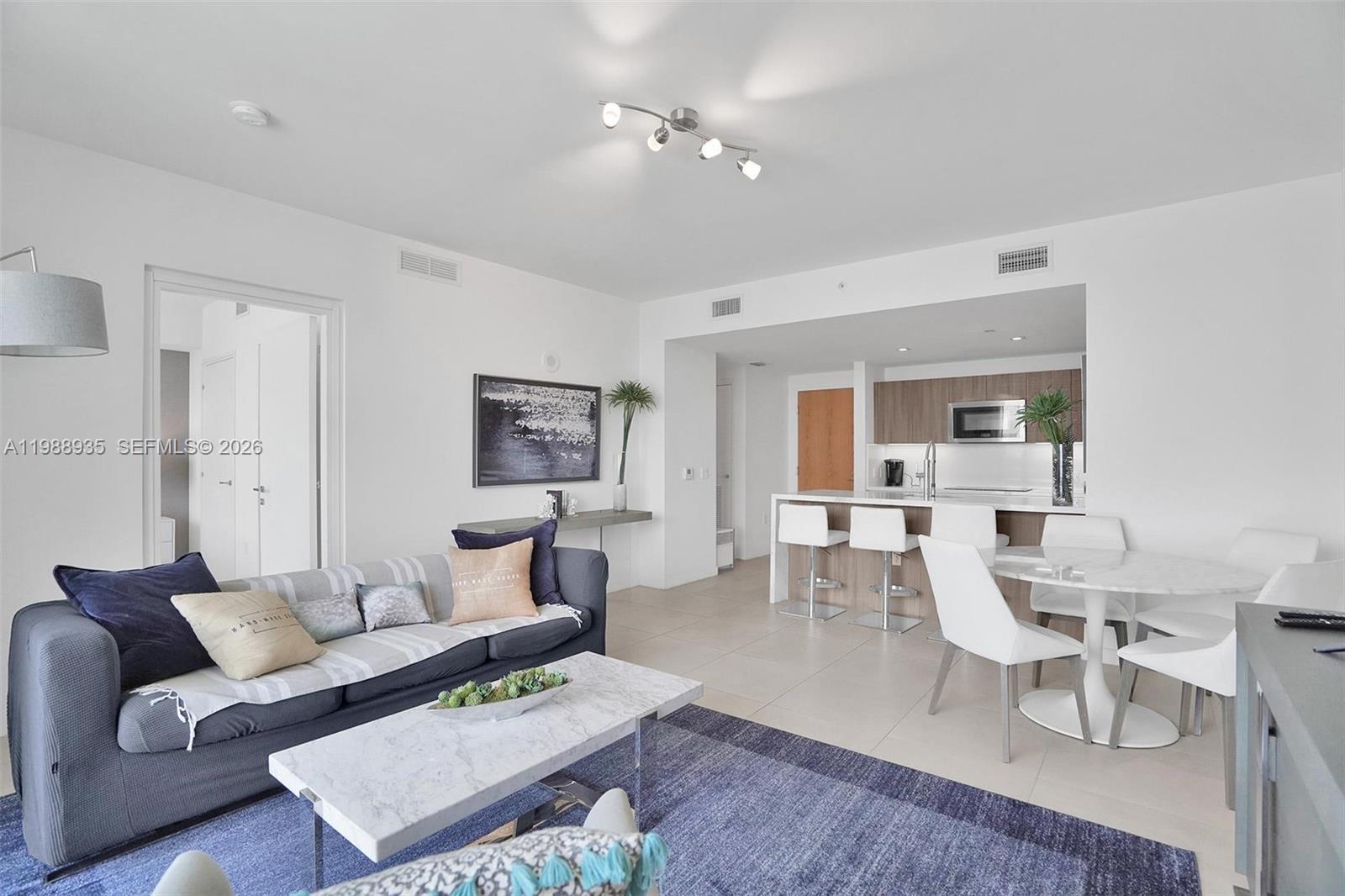 401 North Birch Road, Unit 513 Fort Lauderdale, FL 33304 - Photo 27 of 37 a living room with furniture and a table