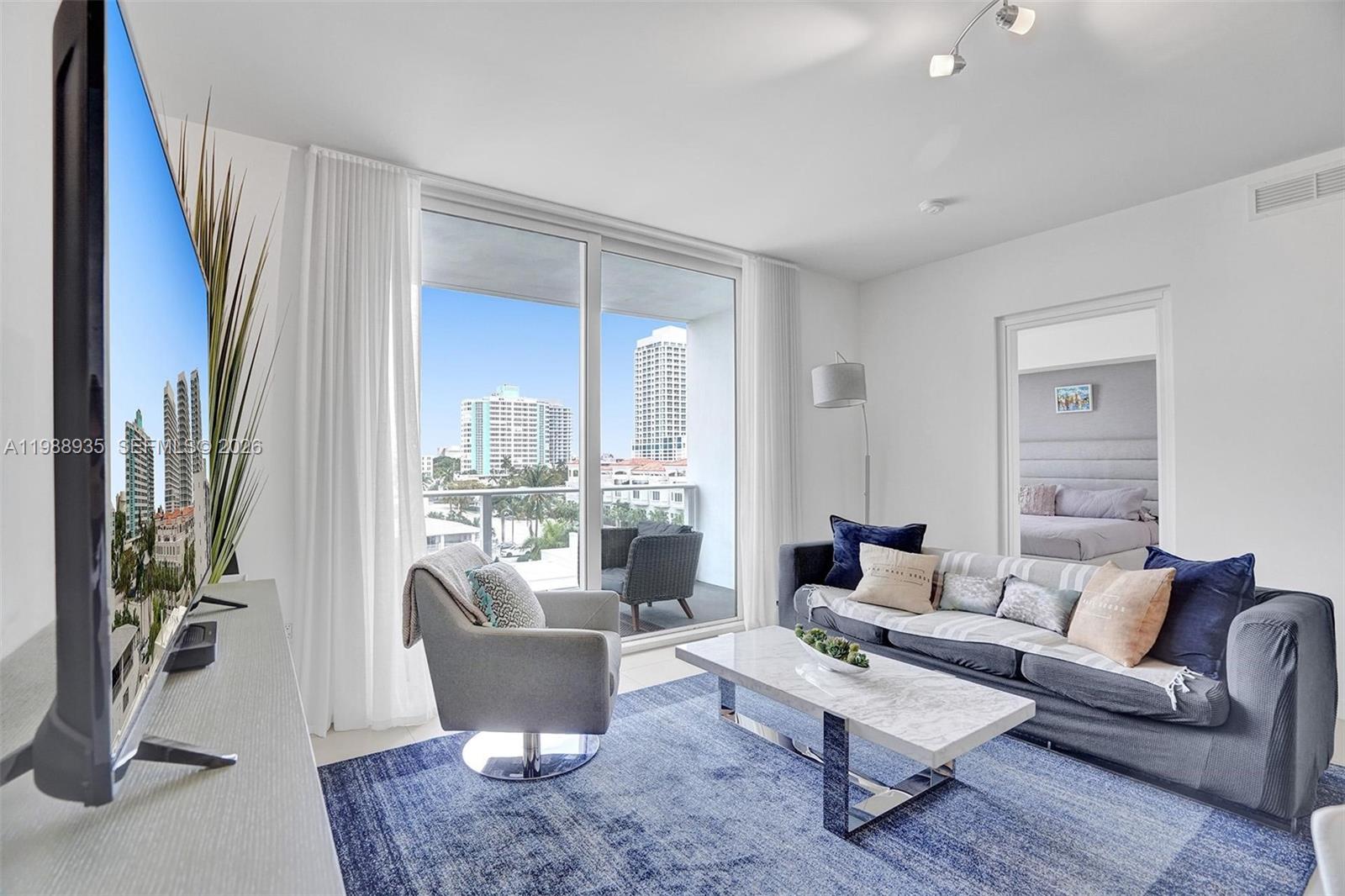 401 North Birch Road, Unit 513 Fort Lauderdale, FL 33304 - Photo 28 of 37 a living room with furniture and a large window