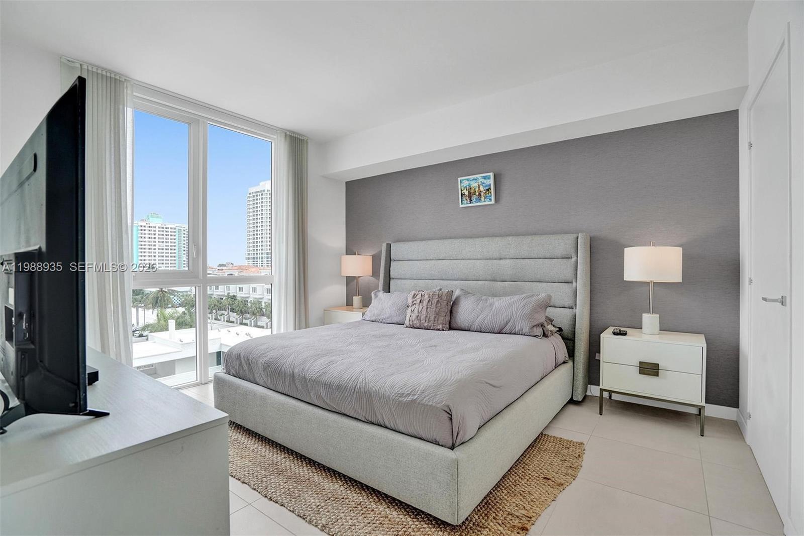 401 North Birch Road, Unit 513 Fort Lauderdale, FL 33304 - Photo 4 of 37 a large bedroom with a bed and large window