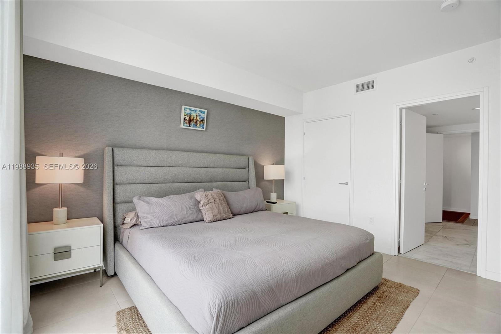 401 North Birch Road, Unit 513 Fort Lauderdale, FL 33304 - Photo 6 of 37 a bedroom with a bed and a walk in closet