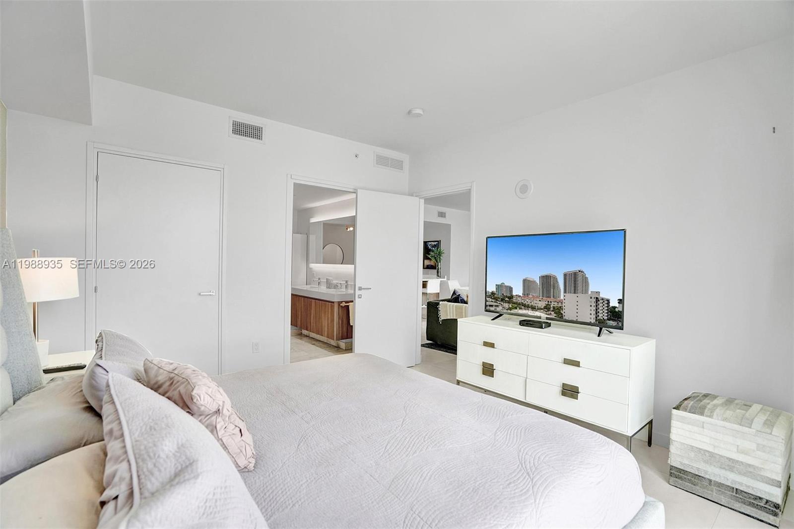 401 North Birch Road, Unit 513 Fort Lauderdale, FL 33304 - Photo 7 of 37 a bedroom with a bed and a view of kitchen