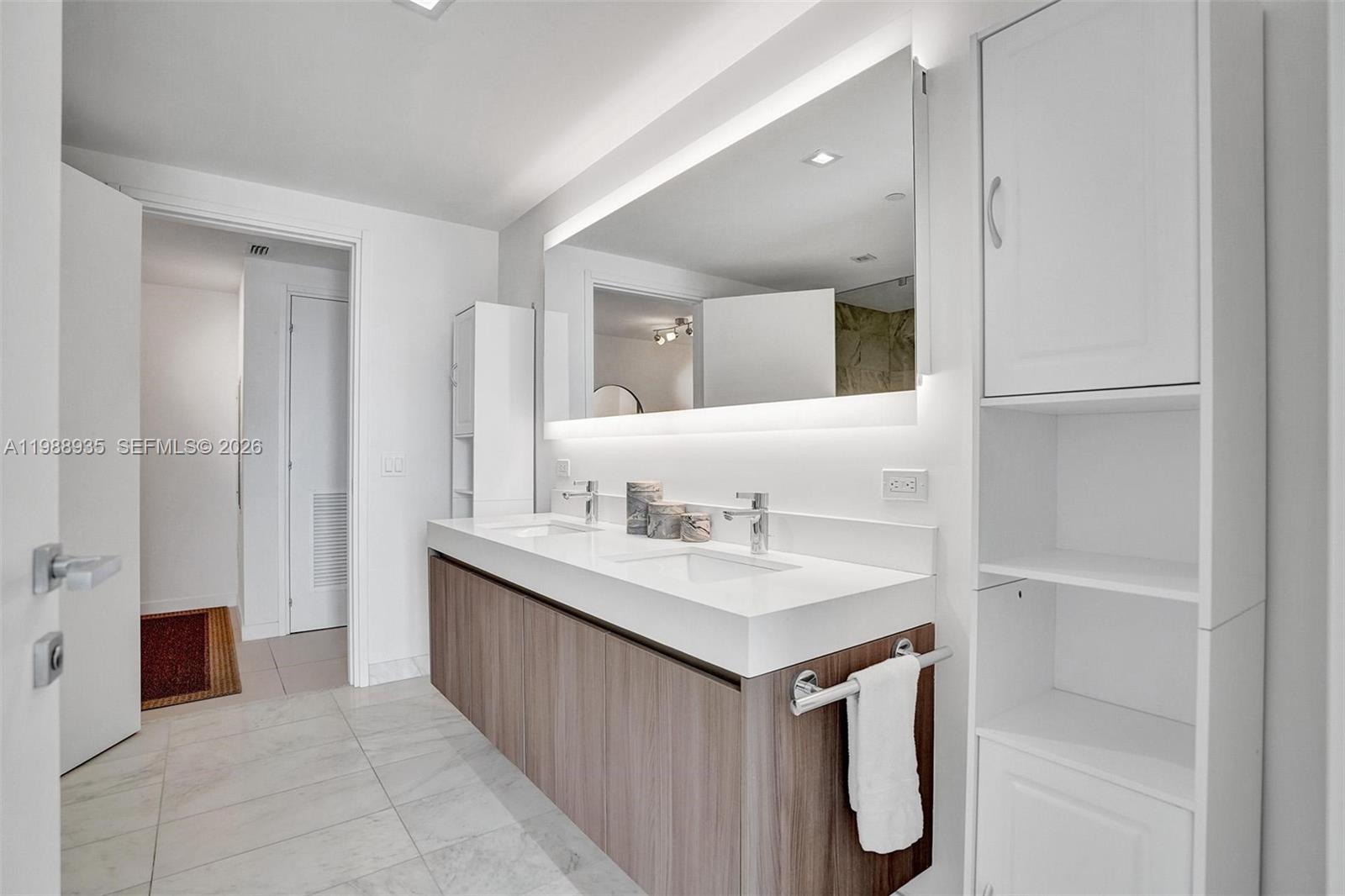 401 North Birch Road, Unit 513 Fort Lauderdale, FL 33304 - Photo 9 of 37 a bathroom with a sink a mirror and a shower