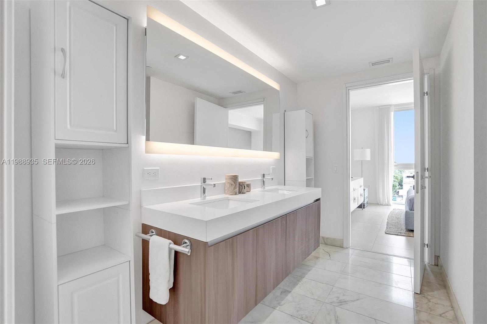 401 North Birch Road, Unit 513 Fort Lauderdale, FL 33304 - Photo 10 of 37 a bathroom with a sink a toilet and a mirror