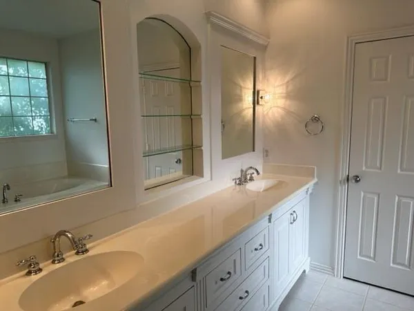a bathroom with a double vanity sink and a mirror