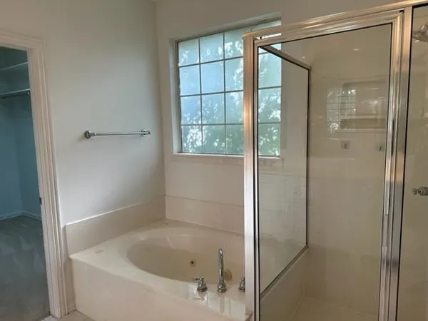 a bathroom with a bathtub and shower
