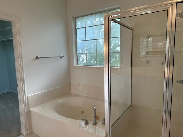 4202 Merrell Road Dallas, TX 75229 - Photo 12 of 16 a bathroom with a bathtub and shower