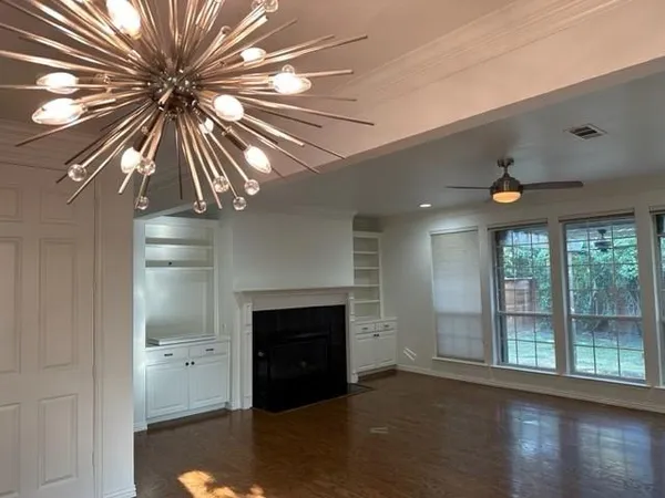 a living room with a large window with a fireplace