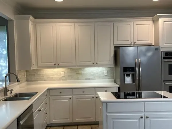 a kitchen with stainless steel appliances granite countertop a sink and cabinets