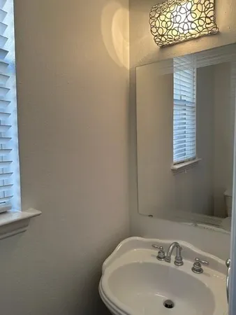 a bathroom with a sink and a window