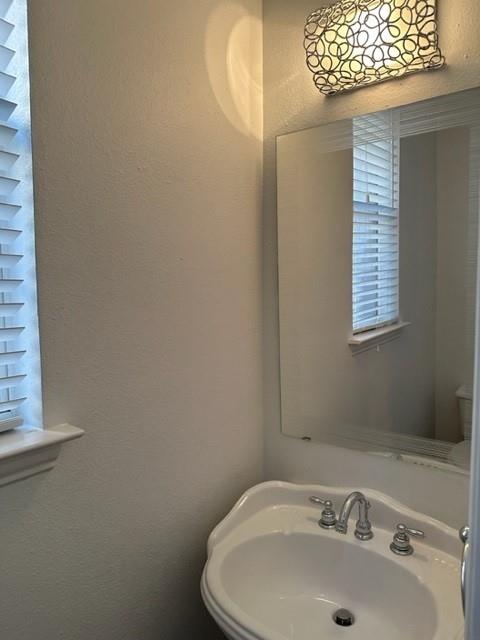 4202 Merrell Road Dallas, TX 75229 - Photo 8 of 16 a bathroom with a sink and a window