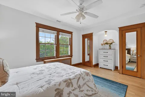a bedroom with a large bed and a window