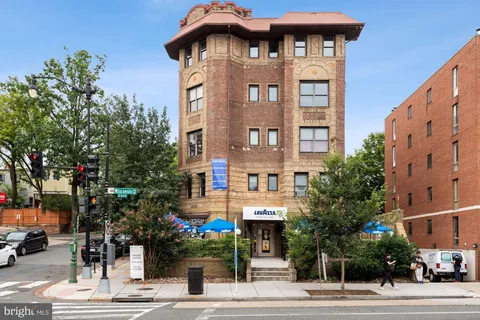 a view of tall building with large windows