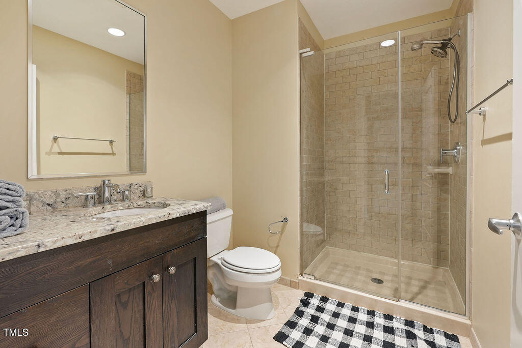 400 West North Street, Unit 604 Raleigh, NC 27603 - Photo 12 of 46 a bathroom with a sink a toilet and shower