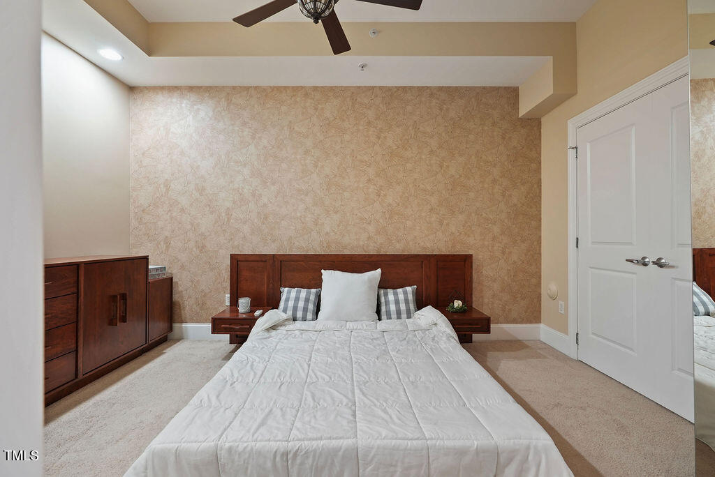 400 West North Street, Unit 604 Raleigh, NC 27603 - Photo 14 of 46 a bedroom with a bed and a dresser