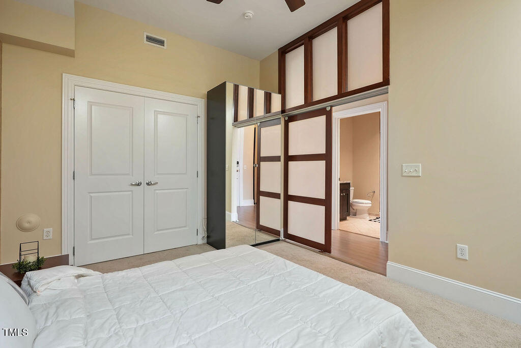 400 West North Street, Unit 604 Raleigh, NC 27603 - Photo 15 of 46 a bedroom with a bed and a window
