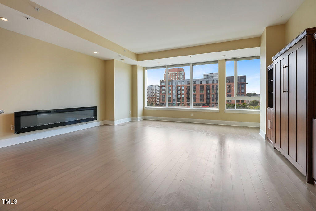 400 West North Street, Unit 604 Raleigh, NC 27603 - Photo 21 of 46 a view of an empty room with wooden floor and a window