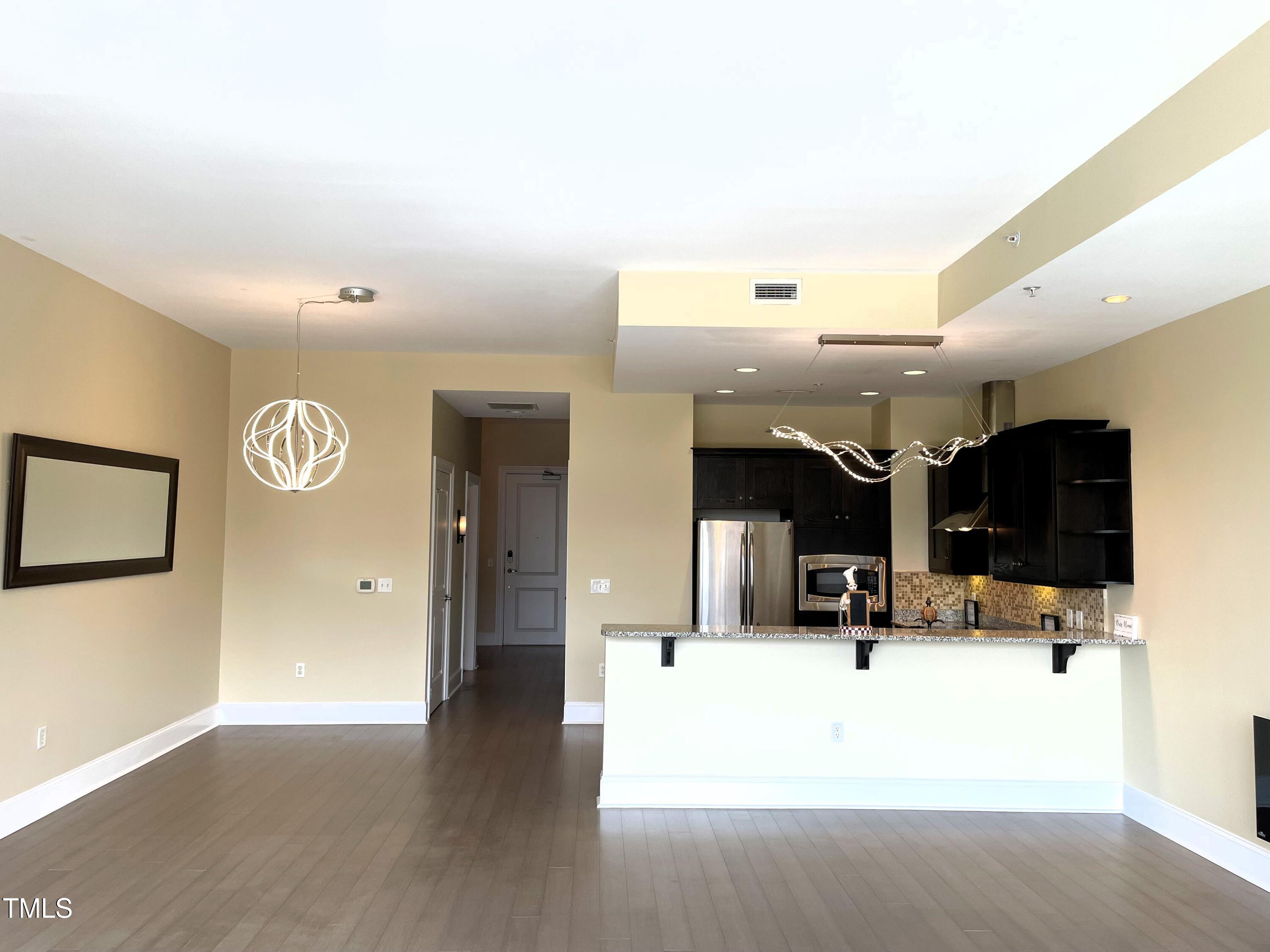 400 West North Street, Unit 604 Raleigh, NC 27603 - Photo 25 of 46 a view of kitchen with furniture and wooden floor