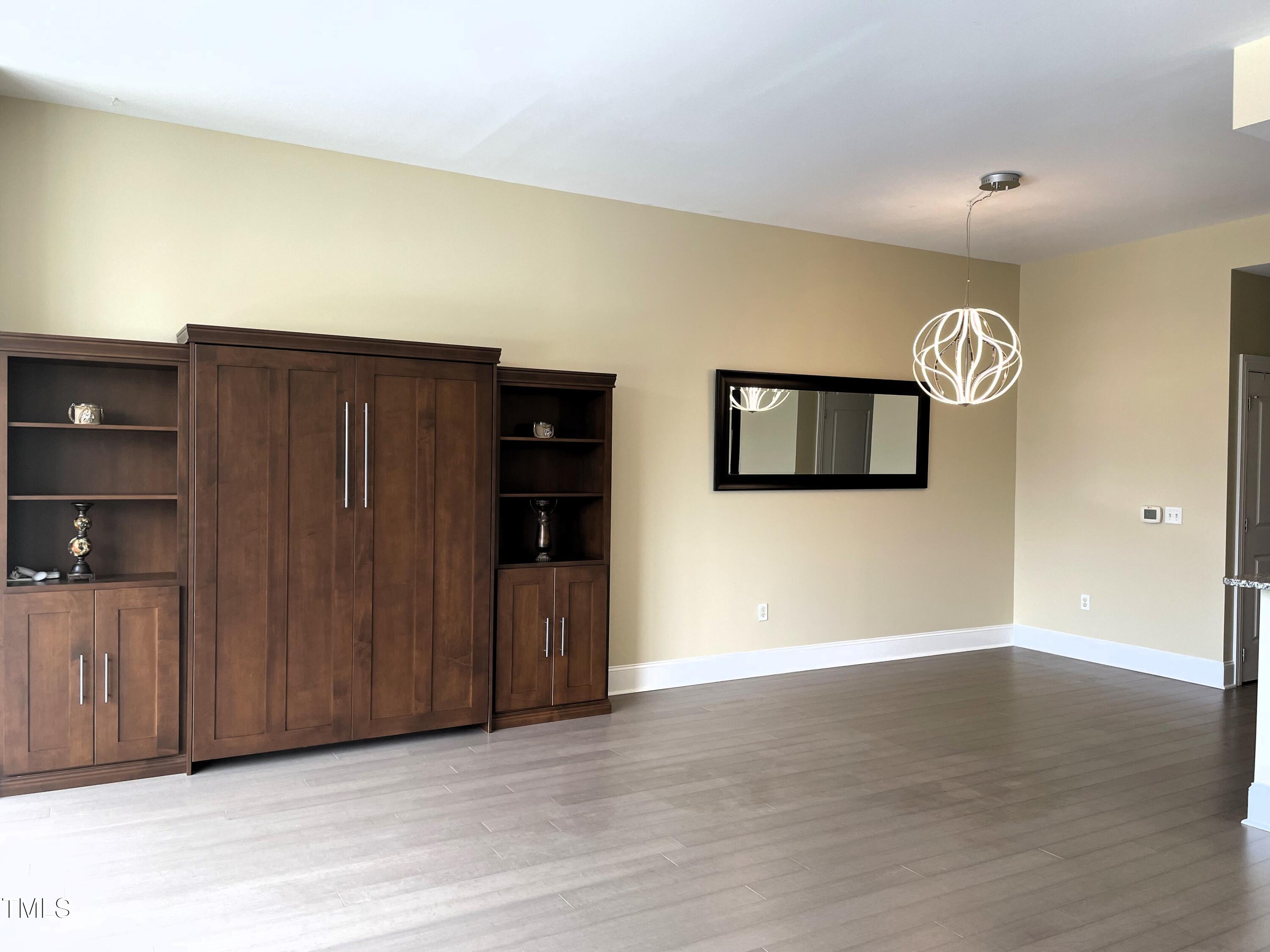 400 West North Street, Unit 604 Raleigh, NC 27603 - Photo 26 of 46 a view of a hallway with wooden floor and cabinet