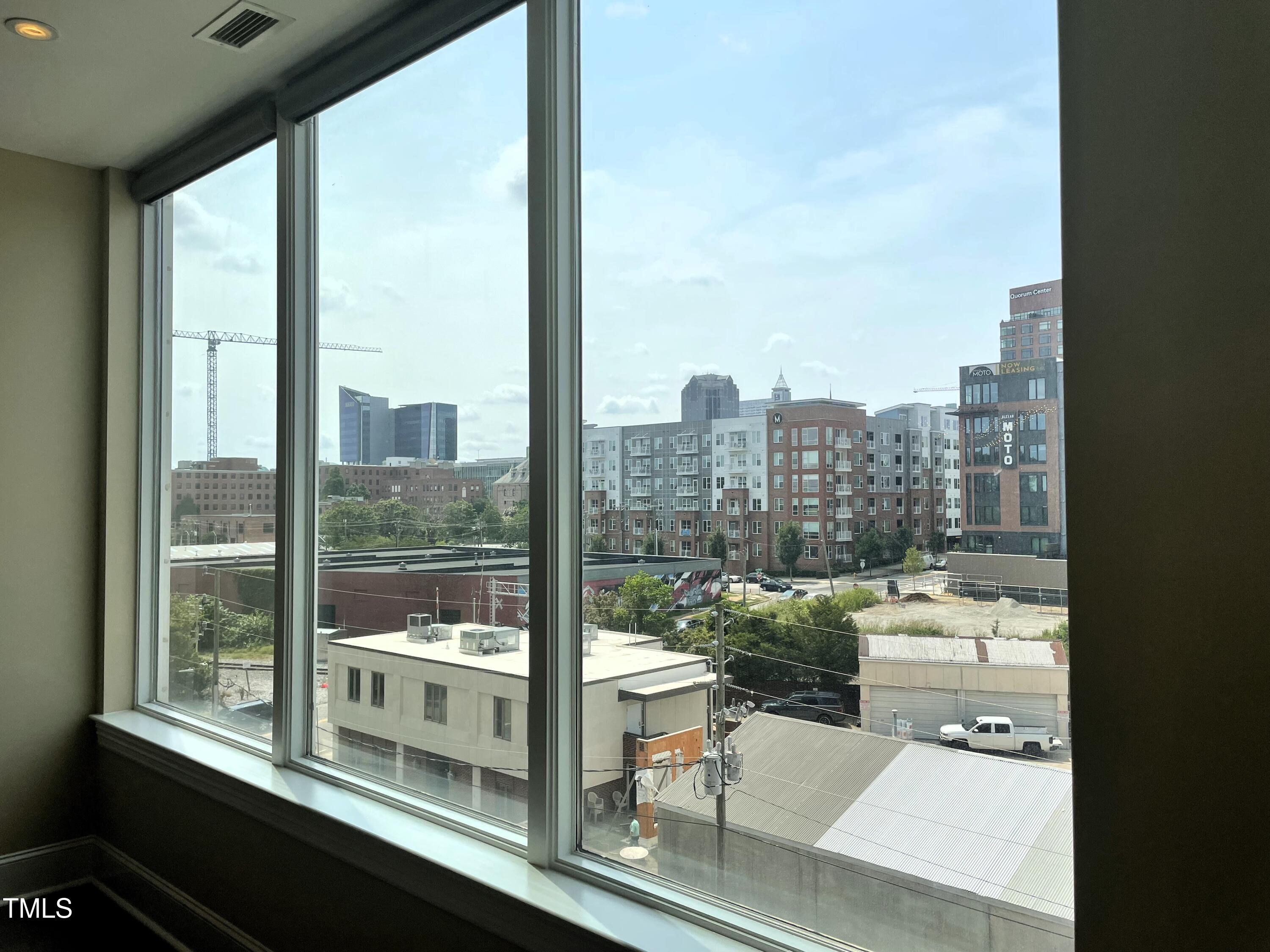 400 West North Street, Unit 604 Raleigh, NC 27603 - Photo 29 of 46 a room with furniture and a floor to ceiling window