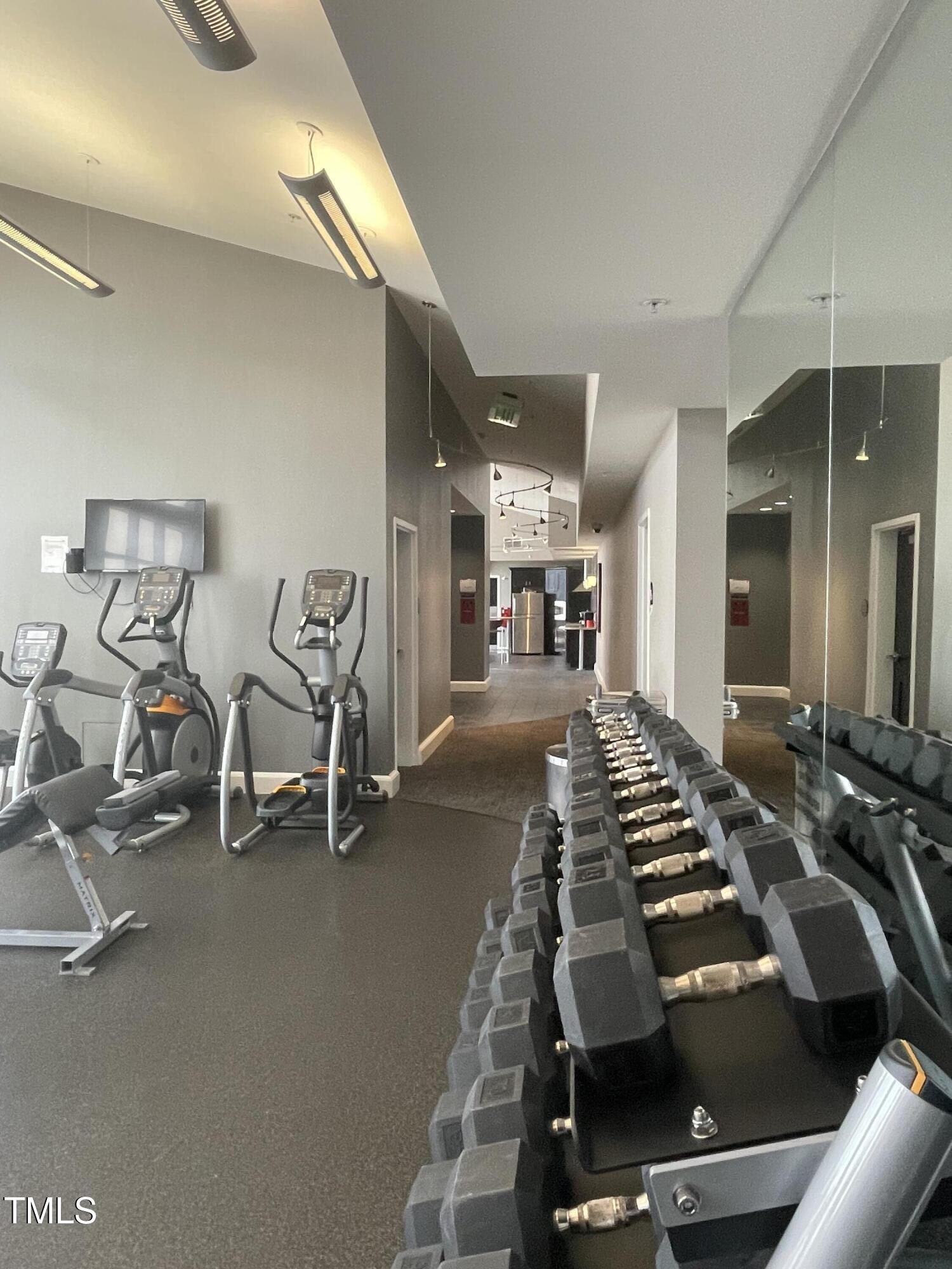 400 West North Street, Unit 604 Raleigh, NC 27603 - Photo 35 of 46 a room with gym equipment and mirrors