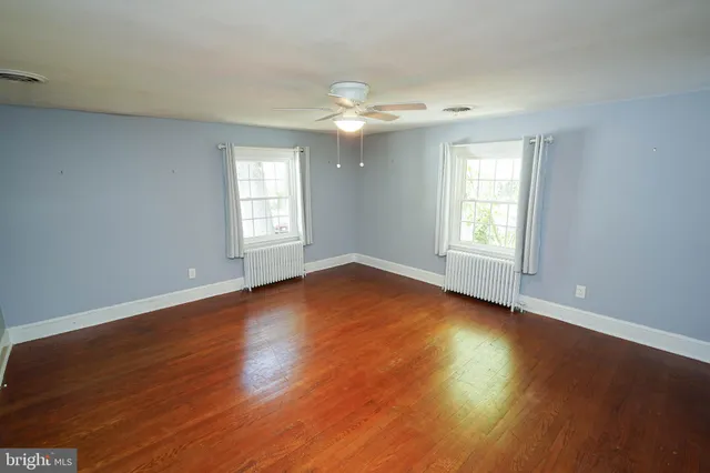 a spacious bathroom with a sink a toilet and a mirror