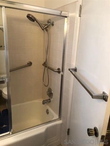 a bathroom with a shower and a glass door