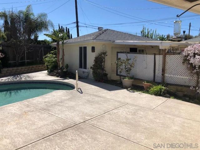 a view of swimming pool with outdoor seating and plants