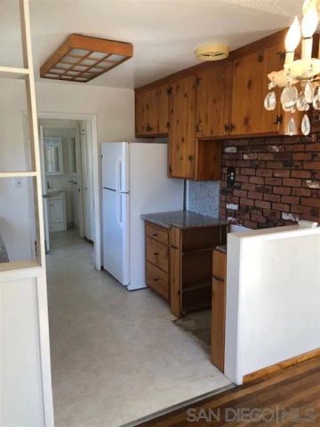 a kitchen with stainless steel appliances a refrigerator and a stove