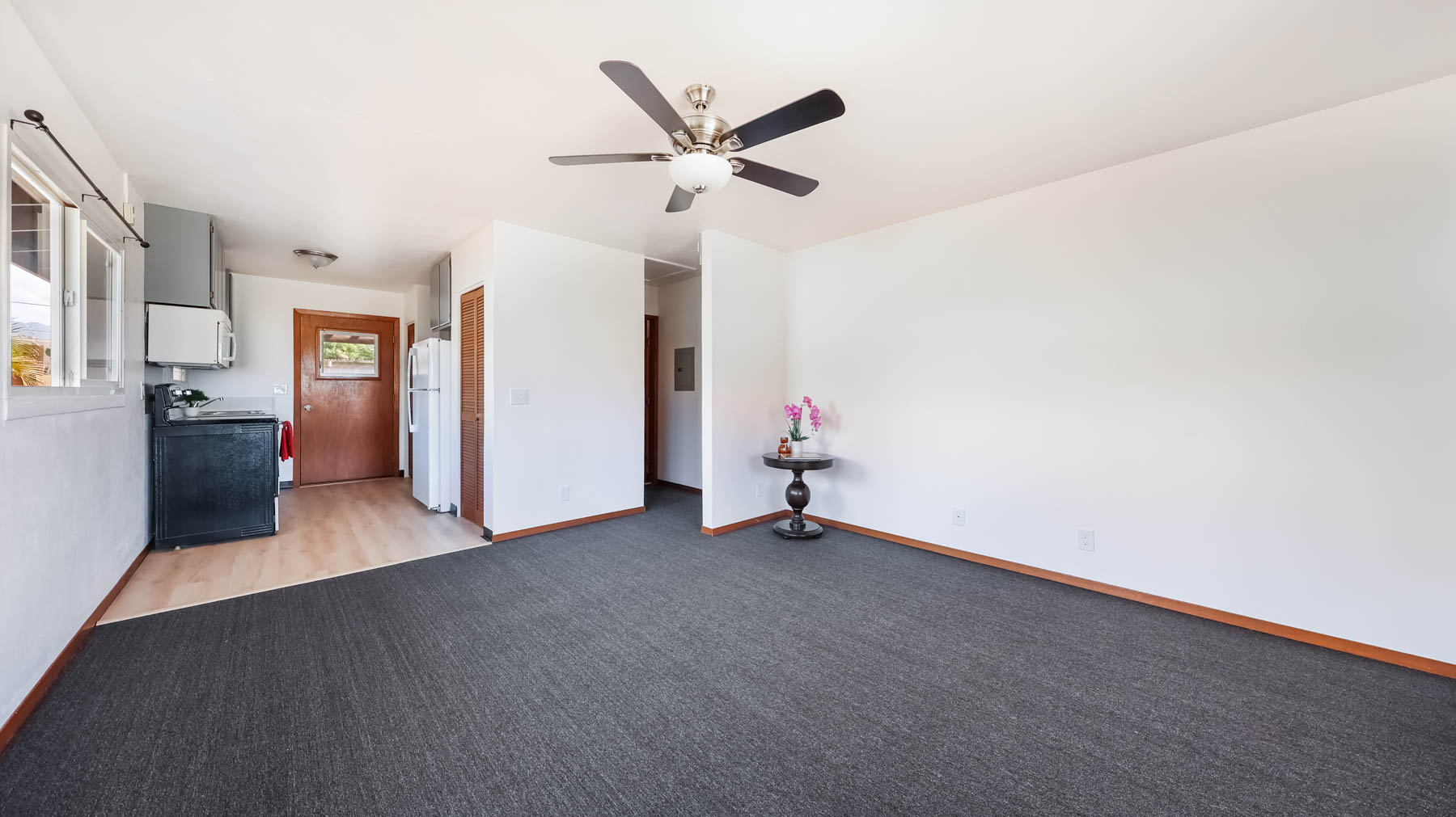 4604 Maile Road Waimea, HI 96796 - Photo 3 of 25 a view of a livingroom with a ceiling fan and kitchen space